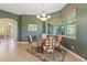 Inviting dining room featuring a large window with backyard views and contemporary chandelier at 1351 Legendary Blvd, Clermont, FL 34711