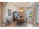 Elegant dining room with stylish chandelier, tray ceiling, and large window at 1351 Legendary Blvd, Clermont, FL 34711