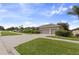 Attractive single-story home featuring a well-manicured lawn and a convenient three-car garage at 1351 Legendary Blvd, Clermont, FL 34711