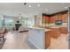 Open concept kitchen with wood cabinets, a breakfast bar, and modern appliances at 1351 Legendary Blvd, Clermont, FL 34711