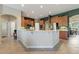Modern kitchen with breakfast bar, stainless steel appliances, and ample counter space at 1351 Legendary Blvd, Clermont, FL 34711