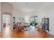 Bright living room featuring hardwood floors and sliding glass doors leading to an outdoor space at 1351 Legendary Blvd, Clermont, FL 34711