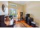 Well-lit home office with vaulted ceiling, hardwood floors, and ample storage space at 1351 Legendary Blvd, Clermont, FL 34711