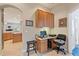 Compact office nook with built-in cabinets, a desk, and a view to the kitchen area at 1351 Legendary Blvd, Clermont, FL 34711