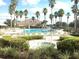 Resort-style pool and spa surrounded by palm trees and lounge chairs, creating a relaxing oasis at 1351 Legendary Blvd, Clermont, FL 34711