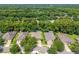 Aerial view of a residential neighborhood featuring tree-lined streets, single-Gathering homes, and lush green landscaping at 1556 Blue Grass Blvd, Deland, FL 32724