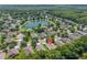 Beautiful aerial view of a residential community with a large lake and lush green landscaping, highlighting the property's location at 1556 Blue Grass Blvd, Deland, FL 32724