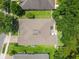 Overhead shot of a well-maintained home with mature landscaping, a backyard patio, and lush green grass at 1556 Blue Grass Blvd, Deland, FL 32724
