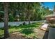 Image showcasing a spacious backyard with white fence, landscaping, and exterior view of home at 1556 Blue Grass Blvd, Deland, FL 32724