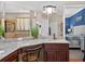 A bathroom featuring a double vanity, granite counters, and a chair at 1556 Blue Grass Blvd, Deland, FL 32724