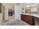 This bathroom features a double vanity with granite countertops and a walk-in closet at 1556 Blue Grass Blvd, Deland, FL 32724