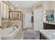 Bright bathroom features a soaking tub and separate glass-enclosed shower at 1556 Blue Grass Blvd, Deland, FL 32724