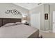 Comfortable bedroom featuring a neutral color scheme, wood headboard, and plenty of closet space at 1556 Blue Grass Blvd, Deland, FL 32724