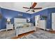 This primary bedroom is large and features wood floors and a ceiling fan at 1556 Blue Grass Blvd, Deland, FL 32724