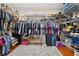 A large walk-in closet with custom shelving and hardwood floors at 1556 Blue Grass Blvd, Deland, FL 32724