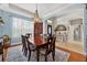 Dining room with wood table, seating for six, and arched entryway at 1556 Blue Grass Blvd, Deland, FL 32724