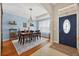 Traditional dining room with elegant chandelier, area rug, and seating for six at 1556 Blue Grass Blvd, Deland, FL 32724