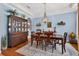 Bright dining room with chandelier and wooden table with seating at 1556 Blue Grass Blvd, Deland, FL 32724