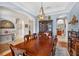 Spacious dining room featuring a large wood table, seating for eight, and decorative furnishings at 1556 Blue Grass Blvd, Deland, FL 32724