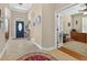 Bright and inviting foyer featuring tile flooring and a view of the home office at 1556 Blue Grass Blvd, Deland, FL 32724
