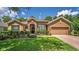 Charming single-story home with manicured lawn, stone accents, and inviting curb appeal at 1556 Blue Grass Blvd, Deland, FL 32724