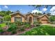 Charming single-story home with manicured lawn, stone accents, and inviting curb appeal at 1556 Blue Grass Blvd, Deland, FL 32724