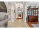Elegant hallway with tile floors, decorative lighting, and arched entryways at 1556 Blue Grass Blvd, Deland, FL 32724