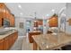 Open kitchen with granite countertops, wood cabinets, and stainless steel appliances at 1556 Blue Grass Blvd, Deland, FL 32724