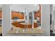 Bright kitchen with granite countertops, stainless steel appliances, and wood cabinets at 1556 Blue Grass Blvd, Deland, FL 32724