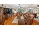 Inviting living room with hardwood floors, plush seating, and natural light at 1556 Blue Grass Blvd, Deland, FL 32724
