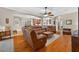 Open-concept living room with hardwood floors and comfortable furniture at 1556 Blue Grass Blvd, Deland, FL 32724
