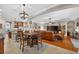 Spacious living room featuring hardwood floors, a ceiling fan, and large TV at 1556 Blue Grass Blvd, Deland, FL 32724