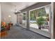 Relaxing sunroom with ceiling fan, tile floors, and views of the beautifully landscaped backyard at 1556 Blue Grass Blvd, Deland, FL 32724