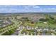 An aerial view of a community featuring a variety of homes, scenic lakes, and lush landscaping at 1721 Germakian Ln, The Villages, FL 32163