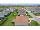Aerial view of the property featuring a spacious backyard, screened lanai, and manicured lawn at 1721 Germakian Ln, The Villages, FL 32163