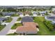 An aerial view showing the backyard, patio area, landscaping, and surrounding neighborhood at 1721 Germakian Ln, The Villages, FL 32163