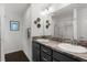 Bathroom boasts double sinks, granite countertops, decorative mirrors, and a glass-enclosed shower at 1721 Germakian Ln, The Villages, FL 32163
