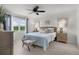 Comfortable bedroom with natural light, soft blue accents, and a ceiling fan at 1721 Germakian Ln, The Villages, FL 32163