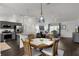 Open concept dining area with hardwood floors, adjacent to the kitchen and living spaces at 1721 Germakian Ln, The Villages, FL 32163