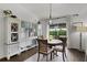 Cozy dining area featuring a round wood table and sliding glass doors to outdoor greenery at 1721 Germakian Ln, The Villages, FL 32163