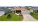 Inviting home with manicured lawn, attractive landscaping, and a two-car attached garage at 1721 Germakian Ln, The Villages, FL 32163
