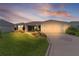 Charming home with a well-manicured lawn, colorful flowerbeds, and a two-car garage at 1721 Germakian Ln, The Villages, FL 32163