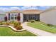 Charming home features a beautifully landscaped front entrance with a cozy screened-in porch at 1721 Germakian Ln, The Villages, FL 32163