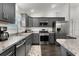 Modern kitchen with stainless steel appliances, granite countertops, and dark wood cabinetry at 1721 Germakian Ln, The Villages, FL 32163