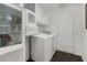 Clean laundry room with washer, dryer, and storage cabinets at 1721 Germakian Ln, The Villages, FL 32163