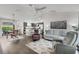 Open-concept living area featuring dining and kitchen, with modern furnishings at 1721 Germakian Ln, The Villages, FL 32163