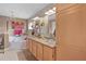 Elegant main bathroom with double sinks, granite counters, modern lighting, and a luxurious soaking tub at 17355 Se 110Th Ter, Summerfield, FL 34491