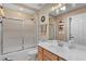 Bright bathroom with marble countertop, tiled shower and modern fixtures at 17355 Se 110Th Ter, Summerfield, FL 34491