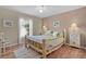 Bright bedroom with hardwood floors, natural wood bed frame and bedside tables at 17355 Se 110Th Ter, Summerfield, FL 34491