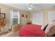 Inviting bedroom featuring wood floors, a ceiling fan, and natural light at 17355 Se 110Th Ter, Summerfield, FL 34491